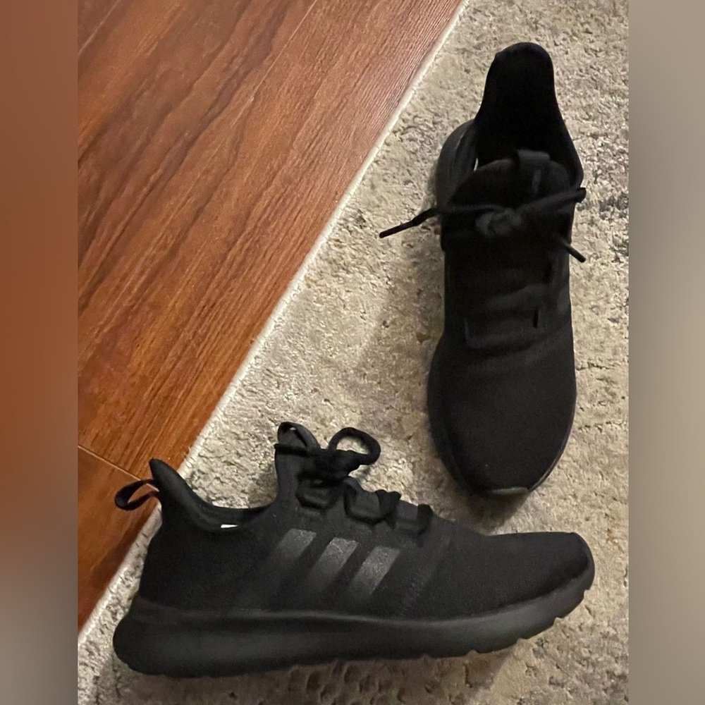 Woman’s size 6 black Adidas sneakers.